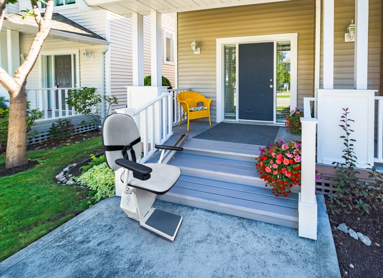 Outdoor stair chair installed on the front porch steps of a family home