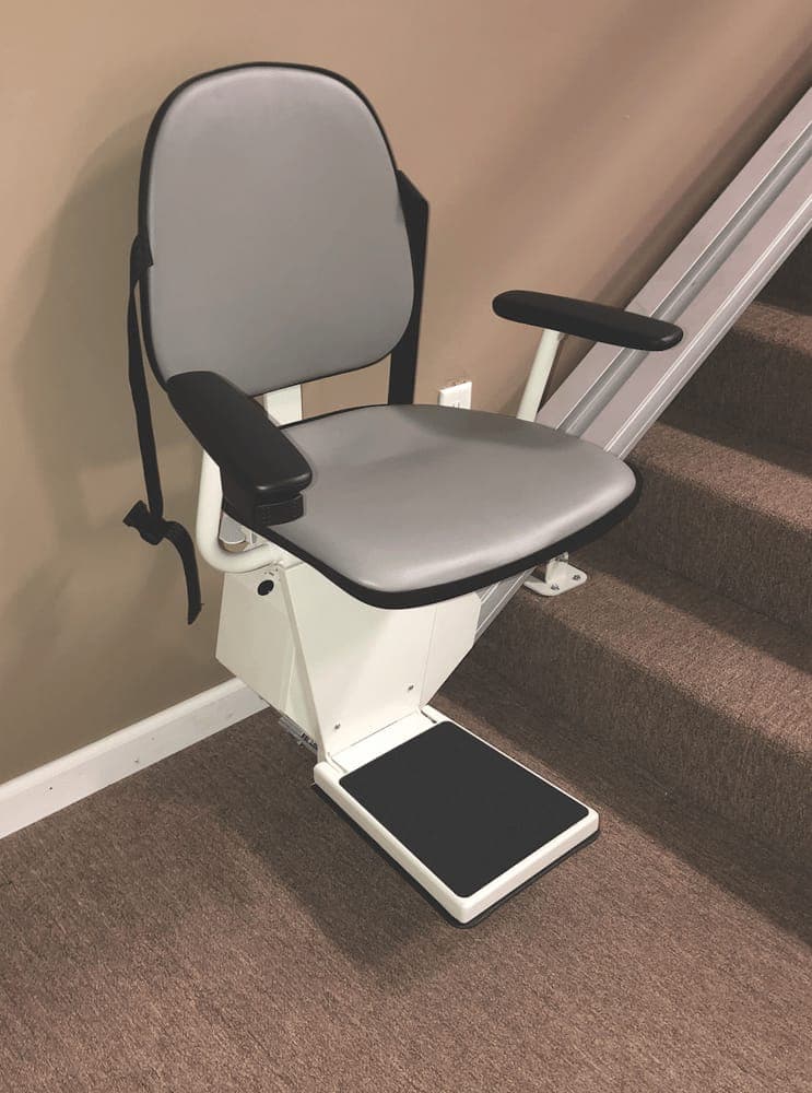 Close-up of a stair chair's padded seat, armrests and footrest