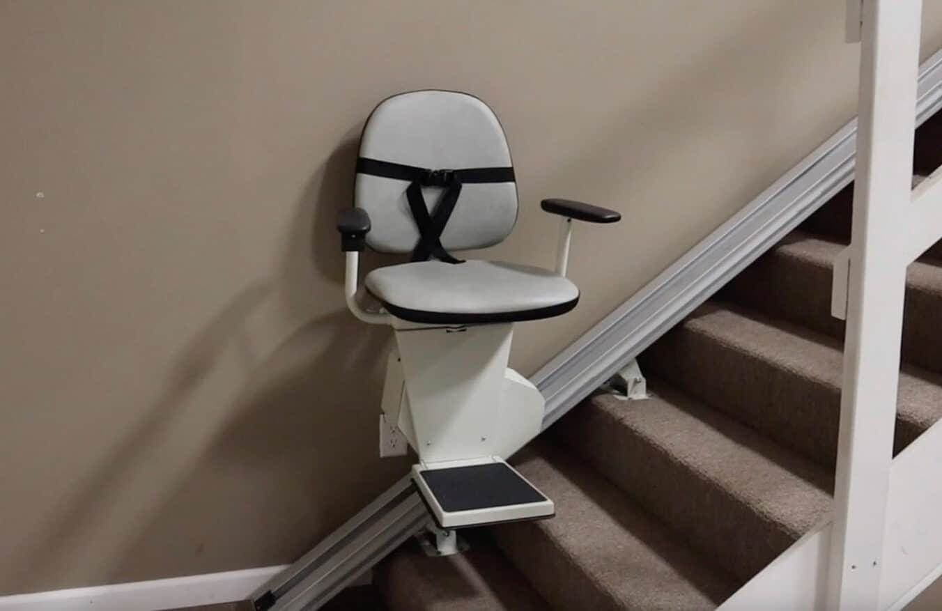 Stair chair on a straight carpeted staircase inside a home