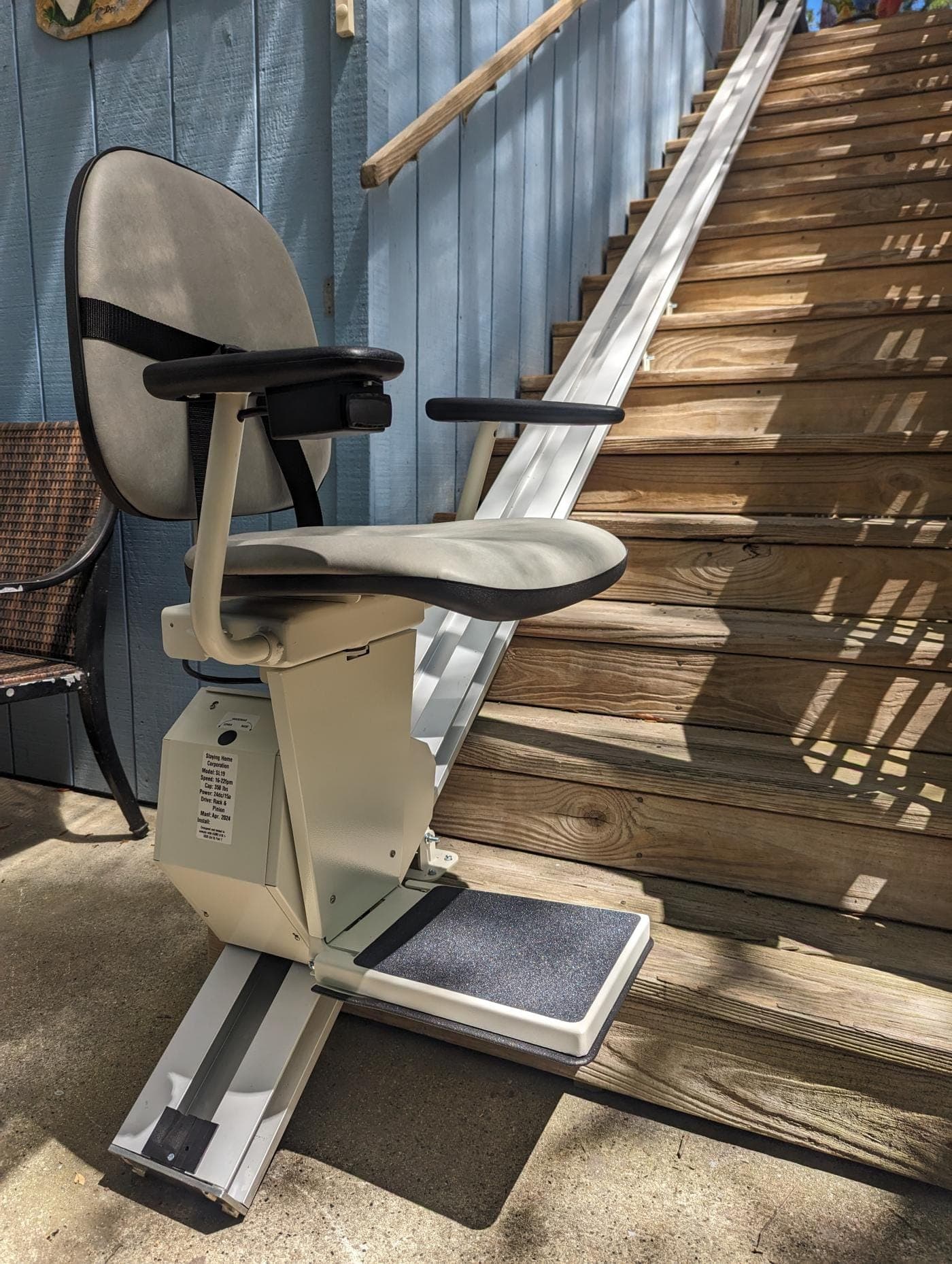 Stair chair installed on a straight wooden staircase
